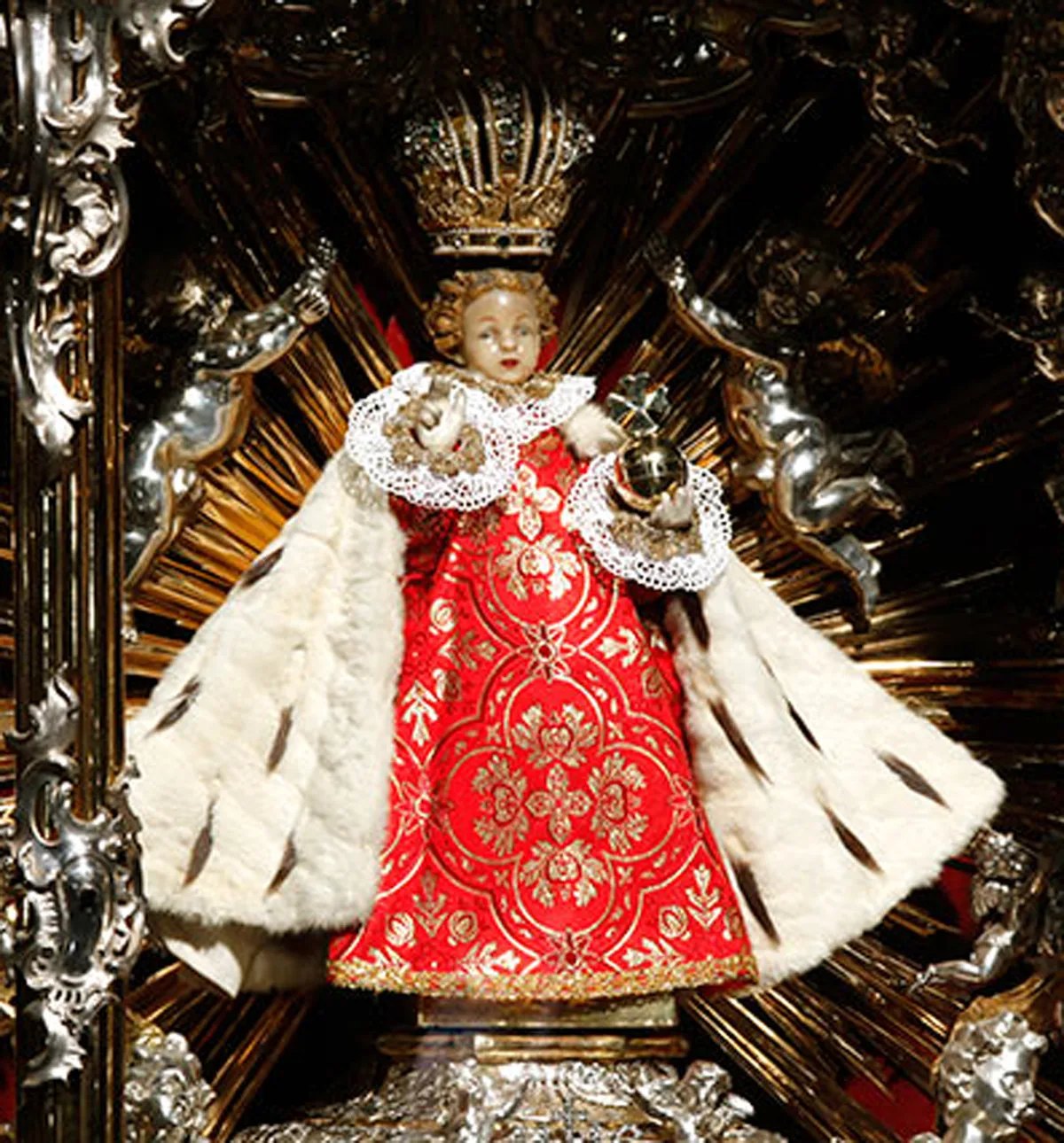 The Infant of Prague statue enthroned on a silver altar with rays of glory in the Church of Our Lady Victorious