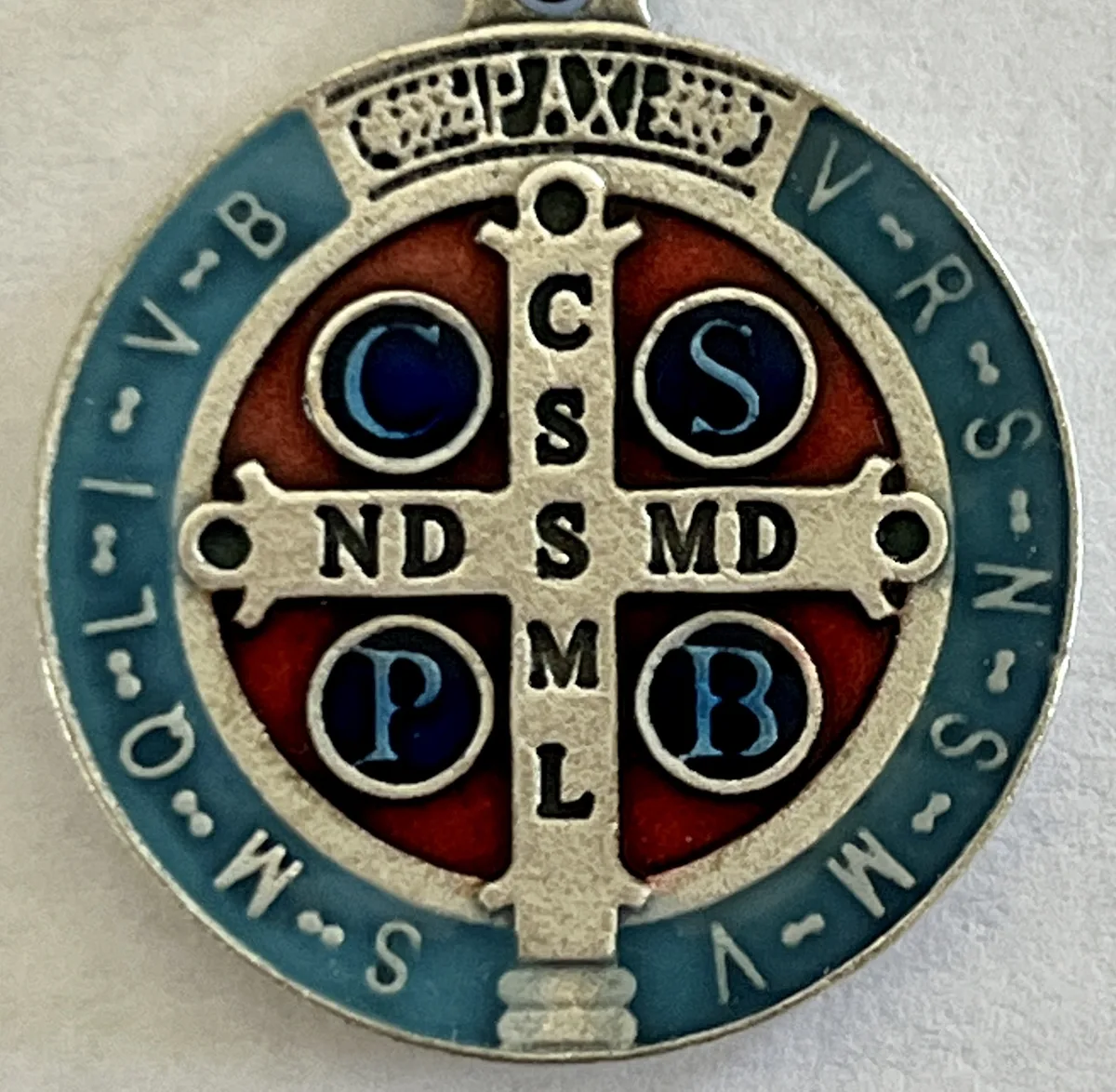 The back of the Saint Benedict Medal, the cross with the letters and the prayer against evil around the rim