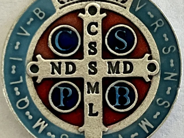 Detail of the back of the Saint Benedict Medal, the cross with the letters CSSML NDSMD and CSPB