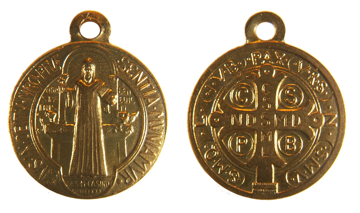The Saint Benedict Medal showing both the front with Saint Benedict and the back with the cross and letters
