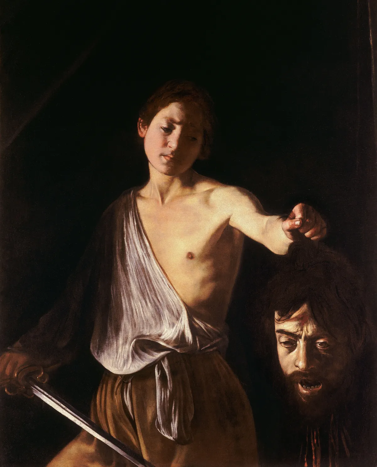Caravaggio, David with the Head of Goliath, a young David holding a sword and the severed head of the giant