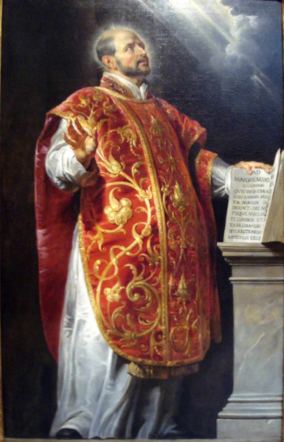 Rubens' Saint Ignatius of Loyola in a black cassock and chasuble, balding and bearded, holding an open book