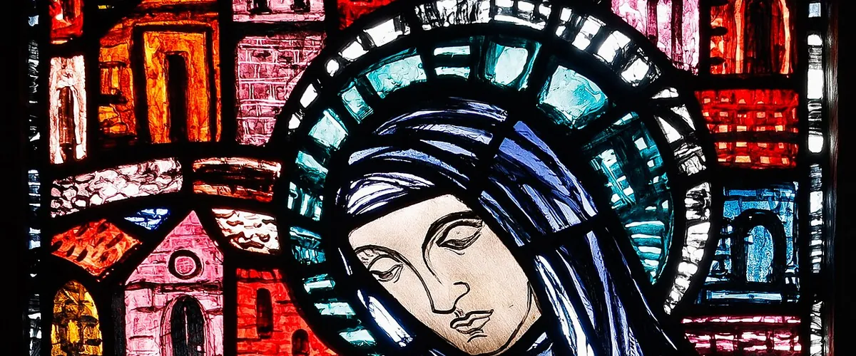 Detail of Evie Hone's Saint Brigid window, the veiled abbess in blue under a green and white halo, the roofs of Kildare behind her