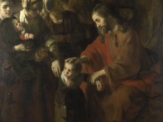 Jesus, seated in a red robe, lays his hand on the head of a small child brought to him by the mothers around him